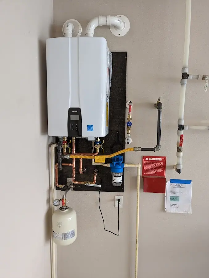 Professional plumber installing copper piping in a Wichita home